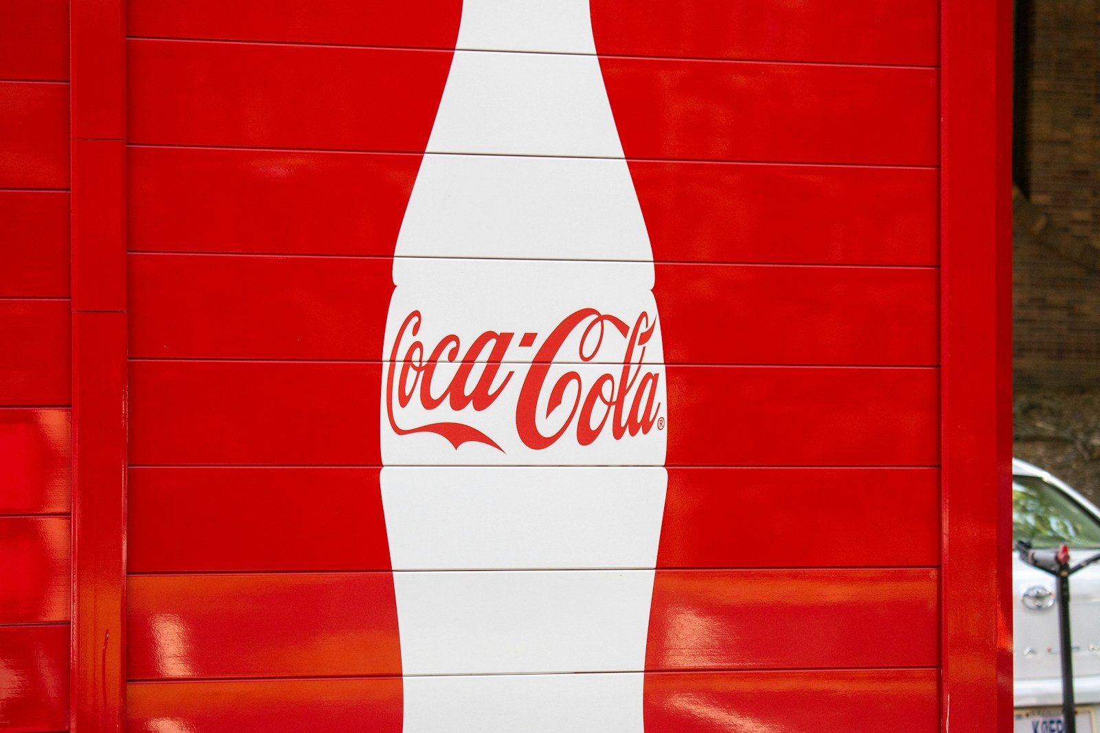 a coca cola sign painted on the side of a building